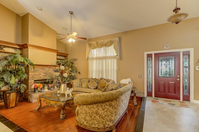 1138 SW Greenbriar Cv, Port Saint Lucie, FL 34986 - living room with a ceiling fan, lofted ceiling, a fireplace, baseboards, and wood finished floors