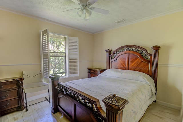 1138 SW Greenbriar Cv, Port Saint Lucie, FL 34986 - bedroom with light wood-style flooring, ornamental molding, a ceiling fan, a textured ceiling, and baseboards