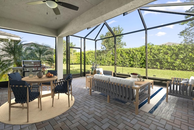 view of patio / terrace with ceiling fan, glass enclosure, an outdoor hangout area, and a grill