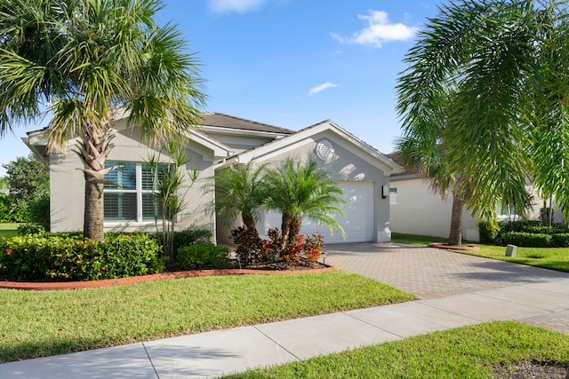 view of front of home featuring a front lawn and a garage