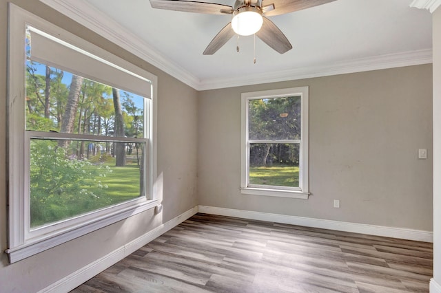 spare room with ornamental molding, ceiling fan, and light hardwood / wood-style floors