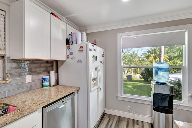 kitchen with white cabinetry, a healthy amount of sunlight, white fridge with ice dispenser, and stainless steel dishwasher