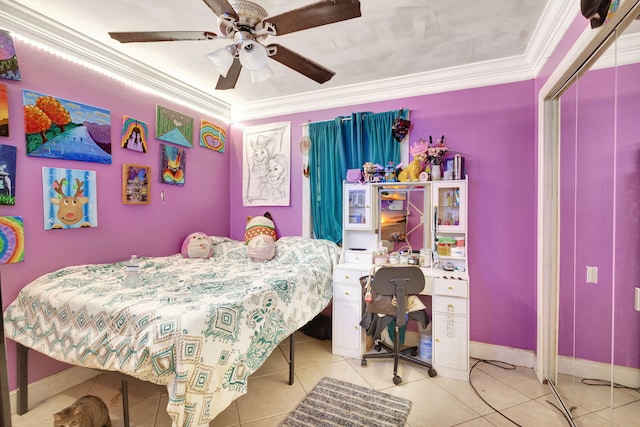 tiled bedroom featuring ceiling fan, a closet, and ornamental molding