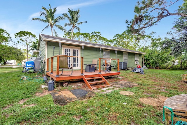 back of property featuring a yard and a deck