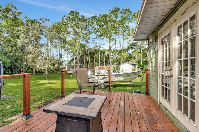 deck featuring french doors and a lawn