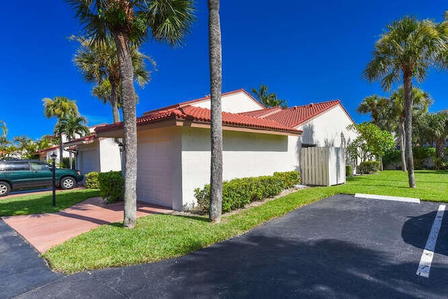 view of home's exterior featuring a yard and a garage