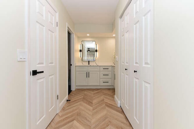 hall with light parquet flooring and sink