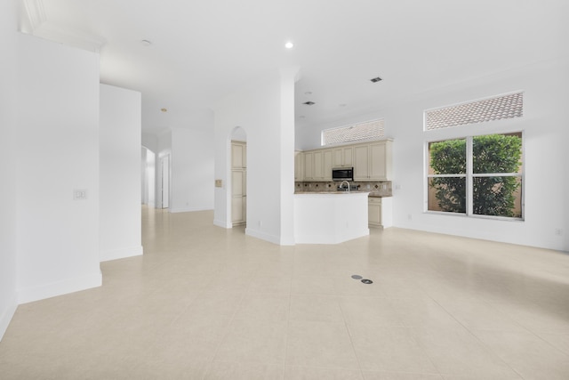 7234 Vesuvio Pl, Boynton Beach, FL 33437 - unfurnished living room featuring arched walkways, baseboards, recessed lighting, and light tile patterned floors