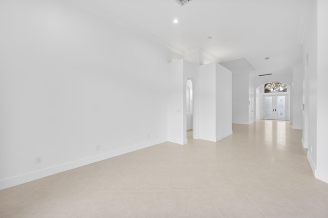 7234 Vesuvio Pl, Boynton Beach, FL 33437 - empty room with arched walkways, light tile patterned flooring, baseboards, recessed lighting, and crown molding