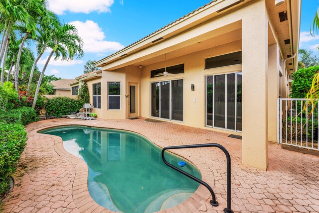 view of swimming pool with a patio and ceiling fan