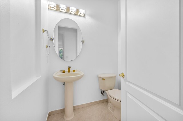 bathroom with toilet and tile patterned floors