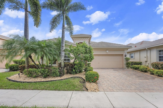 7234 Vesuvio Pl, Boynton Beach, FL 33437 - mediterranean / spanish-style house with a garage, a tile roof, decorative driveway, and stucco siding