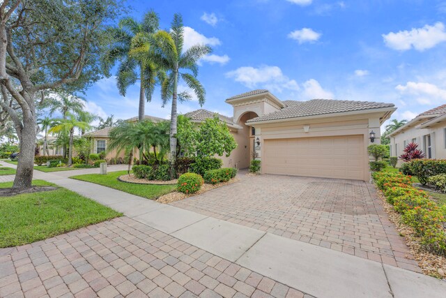 mediterranean / spanish-style home with a garage