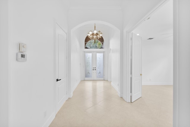 7234 Vesuvio Pl, Boynton Beach, FL 33437 - hall with light tile patterned flooring, french doors, baseboards, a notable chandelier, and visible vents