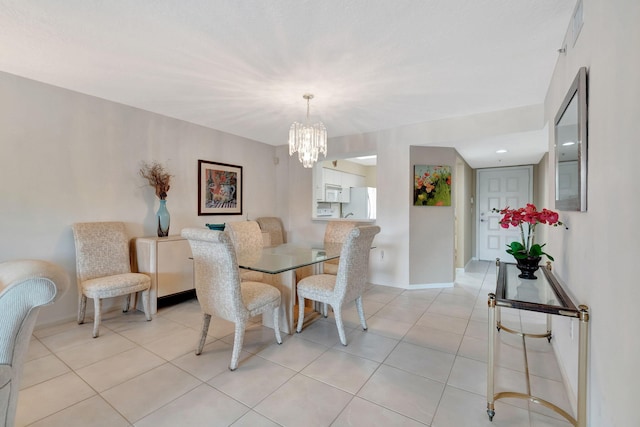 dining room featuring an inviting chandelier and light tile patterned floors