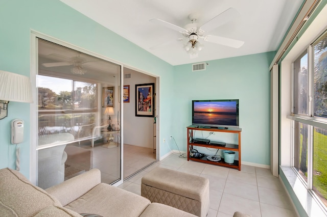 tiled living room featuring ceiling fan