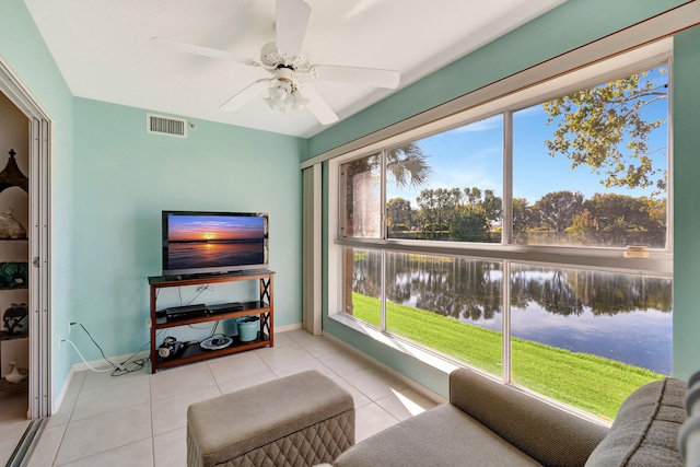 sitting room with ceiling fan, plenty of natural light, and light tile patterned floors