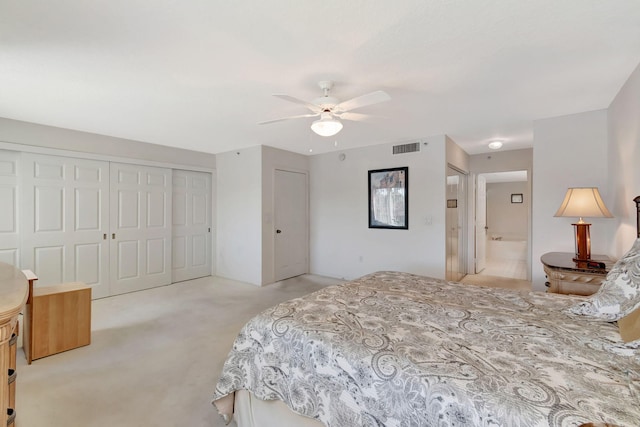 carpeted bedroom with ceiling fan and connected bathroom