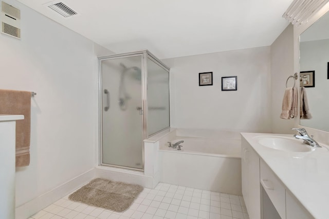 bathroom with tile patterned floors, vanity, and shower with separate bathtub