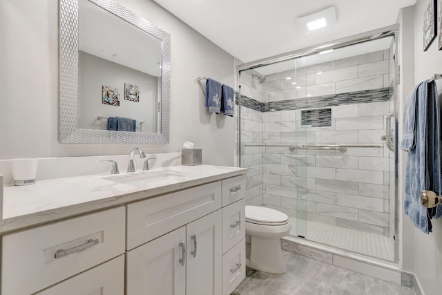 bathroom with an enclosed shower, vanity, and toilet