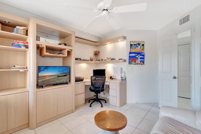 tiled office space featuring ceiling fan and built in desk