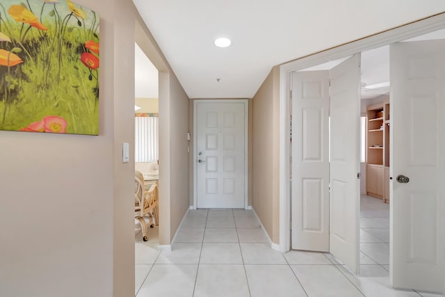 hall featuring light tile patterned flooring