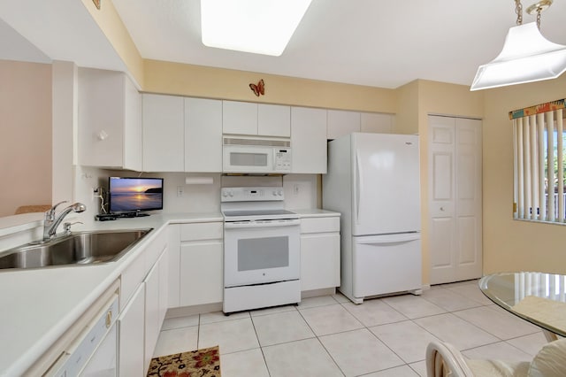 kitchen with white cabinets, white appliances, sink, hanging light fixtures, and light tile patterned floors