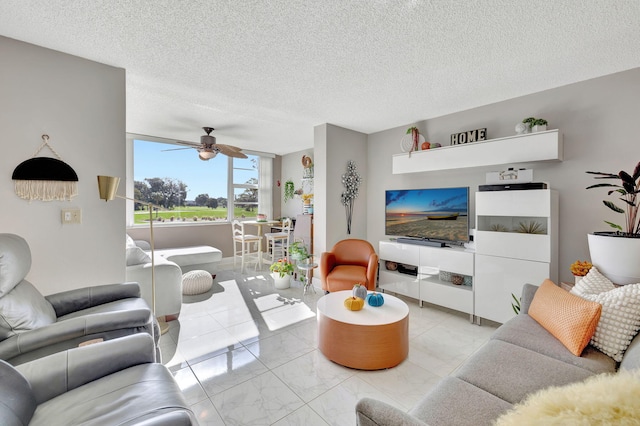 living room with a textured ceiling and ceiling fan