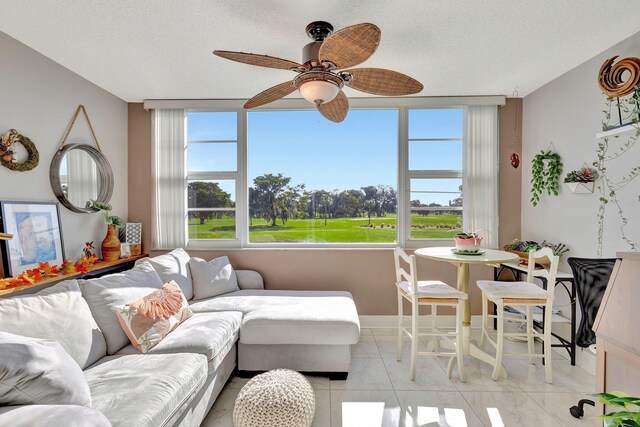 1480 NW 80th Ave Unit 201, Margate, FL 33063 - living room with a ceiling fan, light marble finish flooring, plenty of natural light, baseboards, and a textured ceiling
