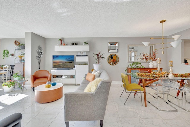 living room featuring a textured ceiling and a chandelier