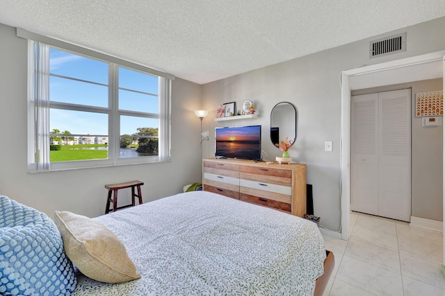 bedroom with a closet and a textured ceiling