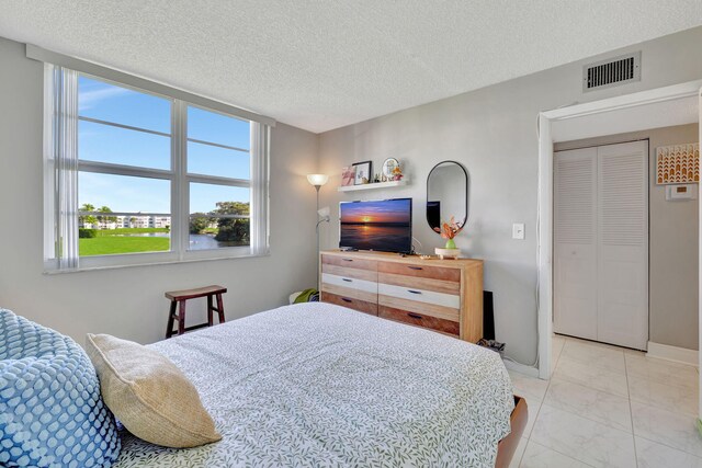 1480 NW 80th Ave Unit 201, Margate, FL 33063 - bedroom featuring light marble finish floors and a textured ceiling