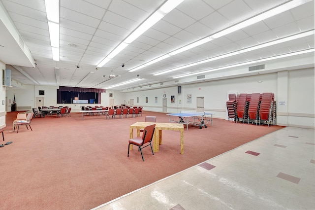 misc room with carpet flooring and a drop ceiling