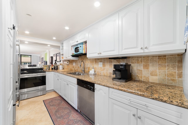 kitchen featuring sink, white cabinets, light tile patterned flooring, appliances with stainless steel finishes, and light stone counters