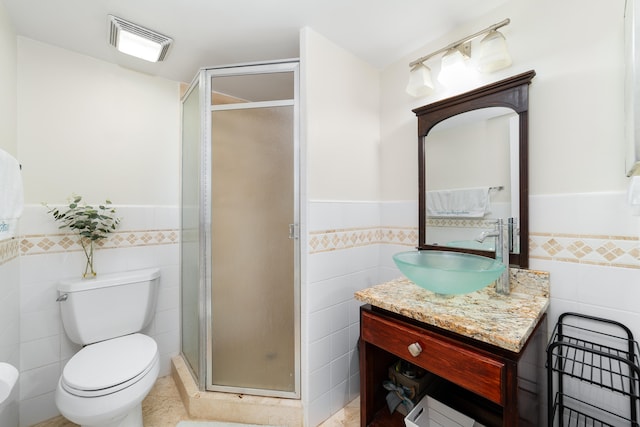 bathroom featuring tile walls, vanity, and an enclosed shower