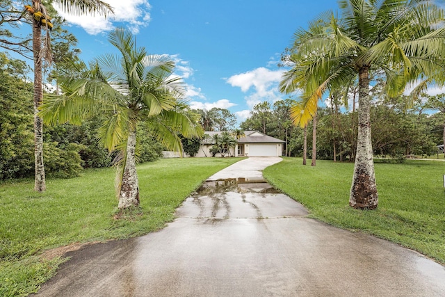 view of front of house with a front yard and a garage