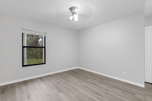 unfurnished room with light hardwood / wood-style floors and a textured ceiling