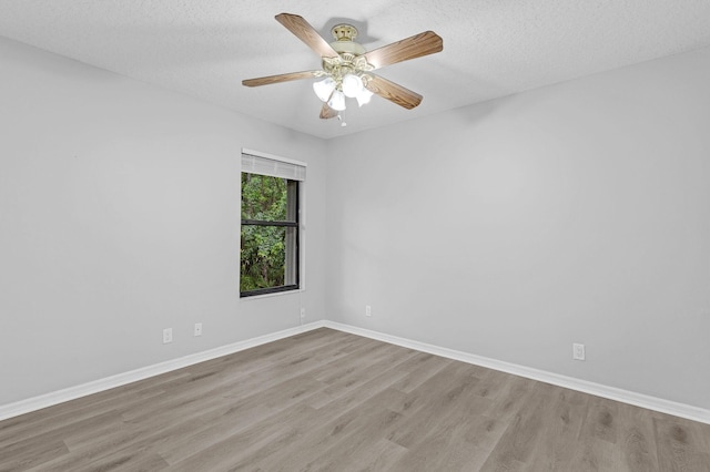 unfurnished room featuring a textured ceiling, ceiling fan, and light hardwood / wood-style flooring