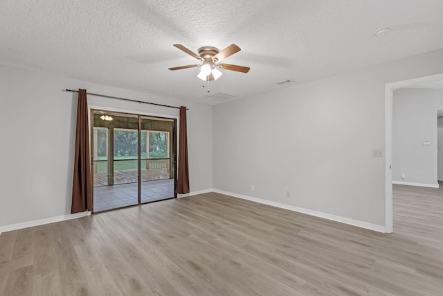 spare room with a textured ceiling, ceiling fan, and light hardwood / wood-style flooring