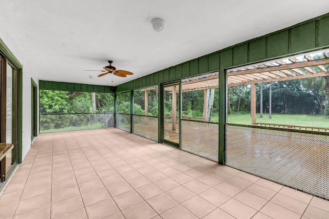 unfurnished sunroom featuring ceiling fan