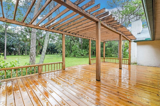 wooden terrace featuring a yard and a pergola