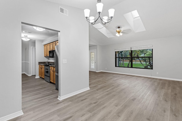 unfurnished living room featuring light wood-type flooring, ceiling fan, and lofted ceiling with skylight