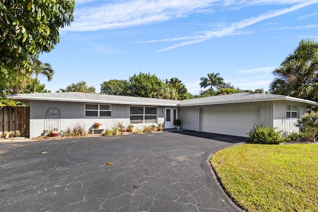 ranch-style home with a front yard and a garage