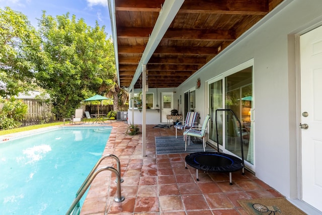 view of swimming pool with a patio area