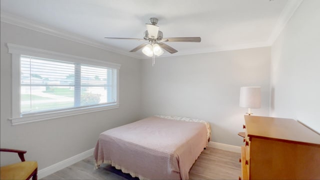 bedroom featuring ornamental molding, light hardwood / wood-style floors, and ceiling fan