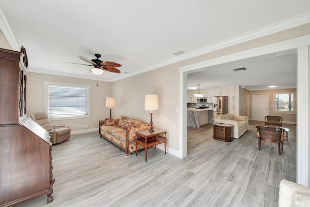 living room featuring ceiling fan, light hardwood / wood-style floors, and crown molding