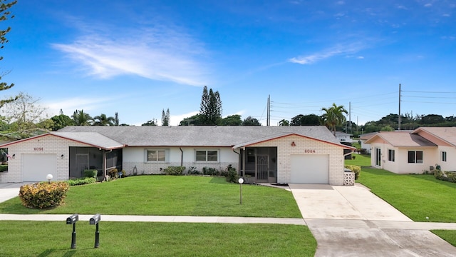 ranch-style house with a garage and a front lawn