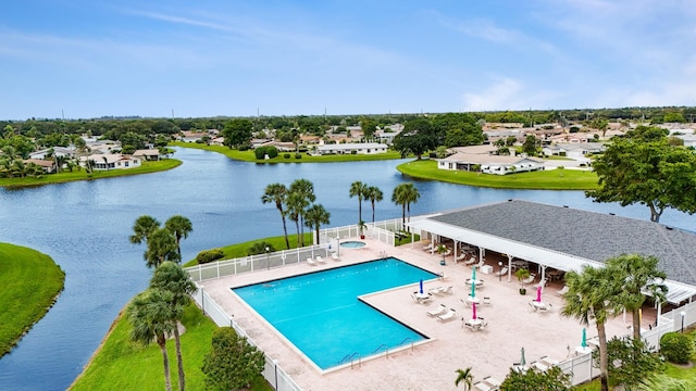 view of pool with a patio and a water view