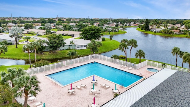 view of swimming pool featuring a water view and a patio area