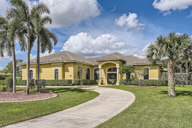 mediterranean / spanish-style house featuring a front lawn